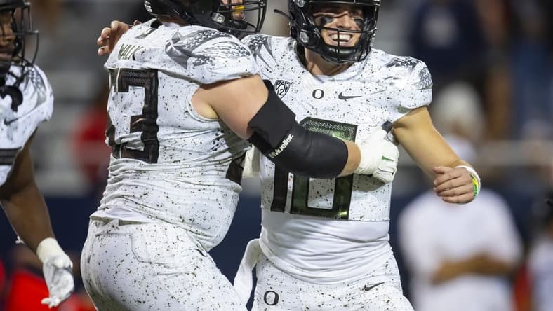 Oct 8, 2022; Tucson, Arizona, USA; Oregon Ducks quarterback Bo Nix (10) celebrates a touchdown with offensive lineman Ryan Walk (53) against the Arizona Wildcats at Arizona Stadium. Mandatory Credit: Mark J. Rebilas-USA TODAY Sports