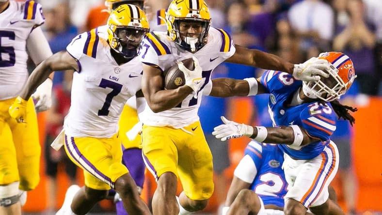 LSU Tigers running back Josh Williams (27) throws a stiff arm to Florida Gators cornerback Jaydon Hill (23) in the second half at Steve Spurrier Field at Ben Hill Griffin Stadium in Gainesville, FL on Saturday, October 15, 2022. LSU defeated the Gators 45-35. [Doug Engle/Gainesville Sun]

Ncaa Football Florida Gators Vs Lsu Tigers