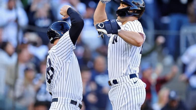 Oct 18, 2022; Bronx, New York, USA; New York Yankees first baseman Anthony Rizzo (48) congratulates designated hitter Giancarlo Stanton (right) after he hit a three-run home run against the Cleveland Guardians during the first inning in game five of the ALDS for the 2022 MLB Playoffs at Yankee Stadium. Mandatory Credit: Brad Penner-USA TODAY Sports