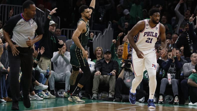 Oct 18, 2022; Boston, Massachusetts, USA; Boston Celtics forward Jayson Tatum (0) signals after making a three point basket over Philadelphia 76ers center Joel Embiid (21) during the first quarter at TD Garden. Mandatory Credit: Winslow Townson-USA TODAY Sports