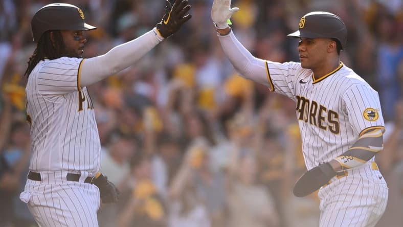 Oct 19, 2022; San Diego, California, USA; San Diego Padres designated hitter Josh Bell (24) congratulates right fielder Juan Soto (22) after scoring a run in the fifth inn against the Philadelphia Phillies during game two of the NLCS for the 2022 MLB Playoffs at Petco Park. Mandatory Credit: Orlando Ramirez-USA TODAY Sports