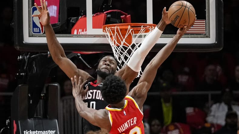 Oct 19, 2022; Atlanta, Georgia, USA; Houston Rockets forward Bruno Fernando (20) blocks a shot by Atlanta Hawks forward De'Andre Hunter (12) during the first quarter at State Farm Arena. Mandatory Credit: Dale Zanine-USA TODAY Sports