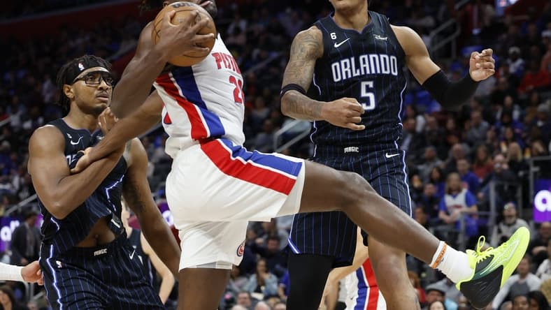 Oct 19, 2022; Detroit, Michigan, USA; Detroit Pistons center Isaiah Stewart (28) grabs the rebound over center Wendell Carter Jr. (34) and Orlando Magic forward Paolo Banchero (5) in the first half at Little Caesars Arena. Mandatory Credit: Rick Osentoski-USA TODAY Sports