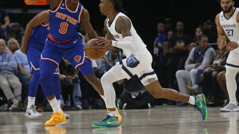Oct 19, 2022; Memphis, Tennessee, USA; Memphis Grizzlies guard Ja Morant (12) dribbles as New York Knicks guard RJ Barrett (9) defends during the first half at FedExForum. Mandatory Credit: Petre Thomas-USA TODAY Sports