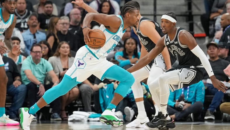 Oct 19, 2022; San Antonio, Texas, USA; Charlotte Hornets guard Dennis Smith Jr. (8) dribbles in front of San Antonio Spurs guard Josh Richardson (7) in the first half at the AT&T Center. Mandatory Credit: Daniel Dunn-USA TODAY Sports