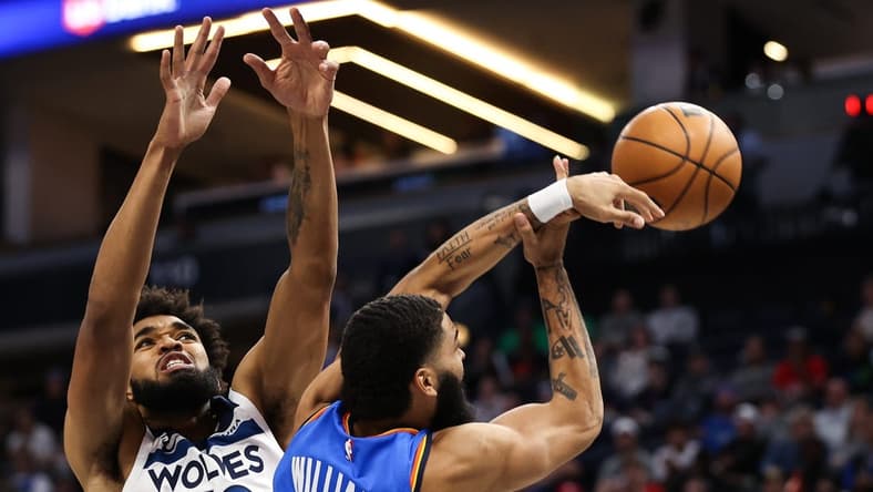 Oct 19, 2022; Minneapolis, Minnesota, USA; Oklahoma City Thunder forward Kenrich Williams (34) attempts a pass while Minnesota Timberwolves center Karl-Anthony Towns (32) defends during the second quarter at Target Center. Mandatory Credit: Matt Krohn-USA TODAY Sports