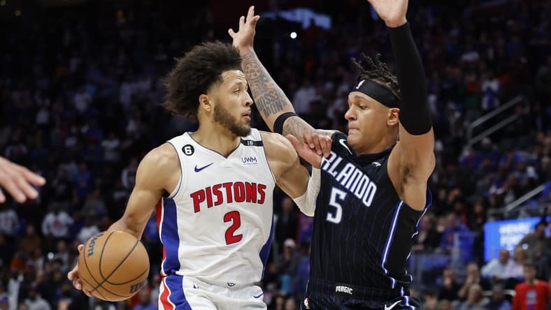 Oct 19, 2022; Detroit, Michigan, USA; Detroit Pistons guard Cade Cunningham (2) is defended by Orlando Magic forward Paolo Banchero (5) in the second half at Little Caesars Arena. Mandatory Credit: Rick Osentoski-USA TODAY Sports