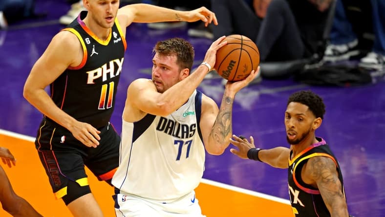 Oct 19, 2022; Phoenix, Arizona, USA; Dallas Mavericks guard Luka Doncic (77) handles the ball against Phoenix Suns center Jock Landale (11) during the first quarter at Footprint Center. Mandatory Credit: Mark J. Rebilas-USA TODAY Sports