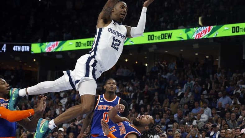 Oct 19, 2022; Memphis, Tennessee, USA; Memphis Grizzlies guard Ja Morant (12) is called for a charge on New York Knicks guard Jalen Brunson (11) with 0.5 second left in regulation at FedExForum. Mandatory Credit: Petre Thomas-USA TODAY Sports