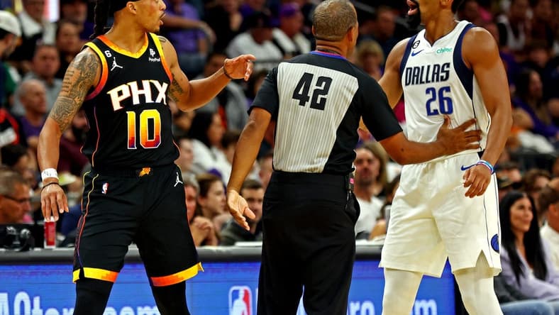 Oct 19, 2022; Phoenix, Arizona, USA; Phoenix Suns guard Damion Lee (10) and Dallas Mavericks guard Spencer Dinwiddie (26) are separated by referee Eric Lewis (42) during the second quarter at Footprint Center. Mandatory Credit: Mark J. Rebilas-USA TODAY Sports