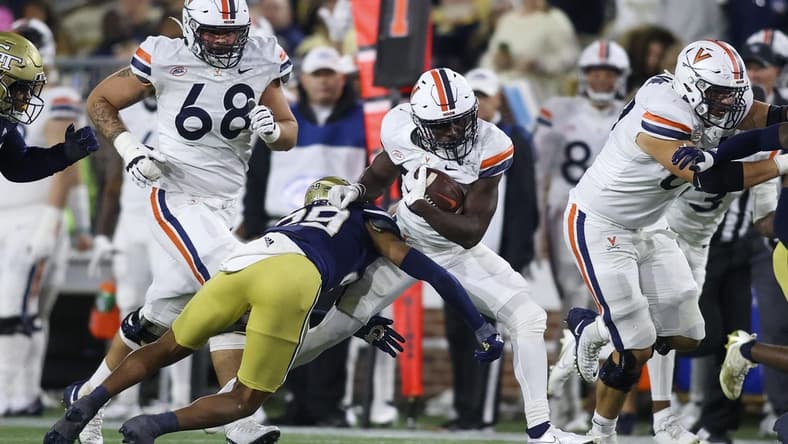 Oct 20, 2022; Atlanta, Georgia, USA; Virginia Cavaliers running back Xavier Brown (20) is tackled by Georgia Tech Yellow Jackets defensive back Clayton Powell-Lee (29) in the first half at Bobby Dodd Stadium. Mandatory Credit: Brett Davis-USA TODAY Sports