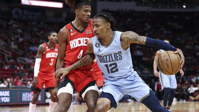 Oct 21, 2022; Houston, Texas, USA; Memphis Grizzlies guard Ja Morant (12) controls the ball as Houston Rockets guard Jalen Green (4) defends during the first quarter at Toyota Center. Mandatory Credit: Troy Taormina-USA TODAY Sports