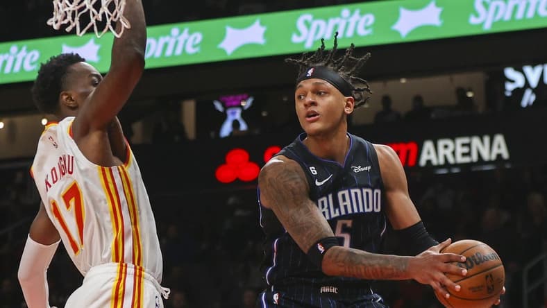 Oct 21, 2022; Atlanta, Georgia, USA; Orlando Magic forward Paolo Banchero (5) passes around Atlanta Hawks forward Onyeka Okongwu (17) in the first quarter at State Farm Arena. Mandatory Credit: Brett Davis-USA TODAY Sports
