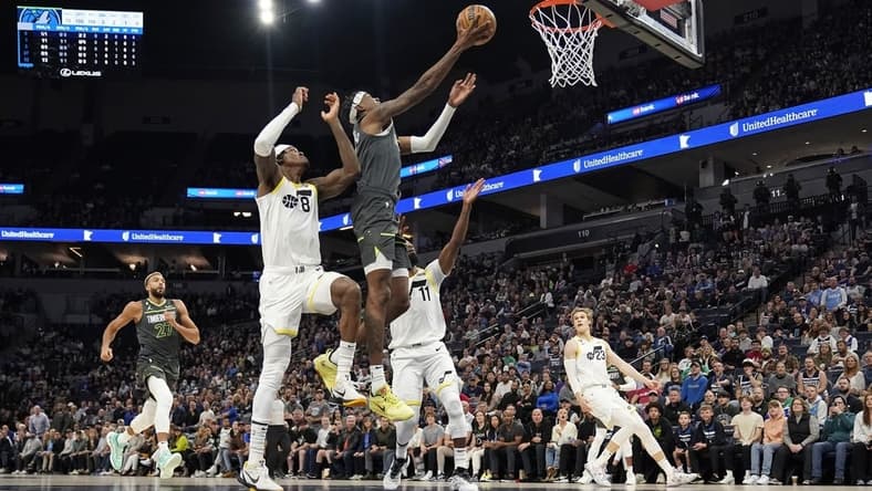 Oct 21, 2022; Minneapolis, Minnesota, USA; Minnesota Timberwolves forward Jaden McDaniels (3) shoots the ball while being fouled by Utah Jazz forward Jarred Vanderbilt (8) during the first quarter at Target Center. Mandatory Credit: Nick Wosika-USA TODAY Sports
