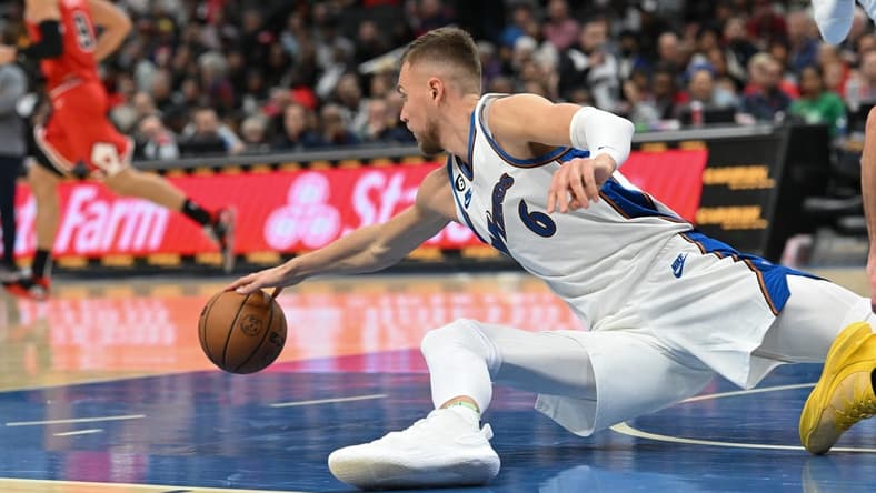 Oct 21, 2022; Washington, District of Columbia, USA; Washington Wizards center Kristaps Porzingis (6) dives for a loose ball during the second half against the Chicago Bulls at Capital One Arena. Mandatory Credit: Tommy Gilligan-USA TODAY Sports