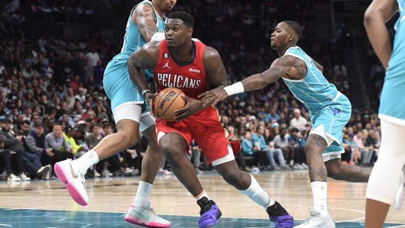 Oct 21, 2022; Charlotte, North Carolina, USA; New Orleans Pelicans forward Zion Williamson (1) drives past Charlotte Hornets forward PJ Washington (25) and guard Terry Rozier (3) during the second half at the Spectrum Center. Mandatory Credit: Sam Sharpe-USA TODAY Sports