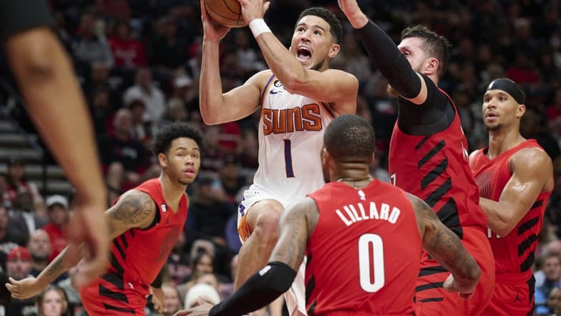 Oct 21, 2022; Portland, Oregon, USA; Phoenix Suns guard Devin Booker (1) drives to the basket during the first half against Portland Trail Blazers center Jusuf Nurkic (27) at Moda Center. Mandatory Credit: Troy Wayrynen-USA TODAY Sports