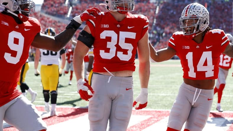 Oct 22, 2022; Columbus, Ohio, USA; Ohio State Buckeyes linebacker Tommy Eichenberg (35) celebrates his interception return for a touchdown with safety Ronnie Hickman (14) and defensive end Zach Harrison (9) during the second quarter against the Iowa Hawkeyes at Ohio Stadium. Mandatory Credit: Joseph Maiorana-USA TODAY Sports