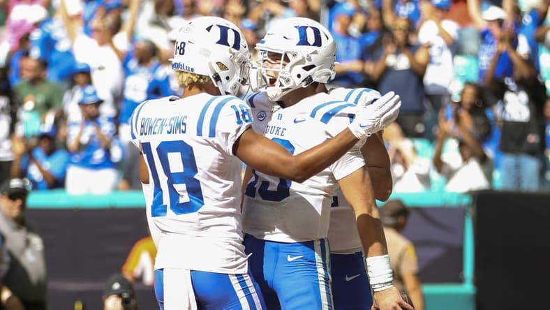 Oct 22, 2022; Miami Gardens, Florida, USA; Duke Blue Devils quarterback Riley Leonard (13) celebrates with wide receiver Malik Bowen-Sims (18) after scoring a touchdown during the fourth quarter against the Miami Hurricanes at Hard Rock Stadium. Mandatory Credit: Sam Navarro-USA TODAY Sports