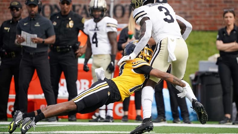 Oct 22, 2022; Columbia, Missouri, USA; Vanderbilt Commodores wide receiver Quincy Skinner Jr. (3) runs the ball as Missouri Tigers defensive back Kris Abrams-Draine (14) makes the tackle during the first half of the game at Faurot Field at Memorial Stadium. Mandatory Credit: Denny Medley-USA TODAY Sports