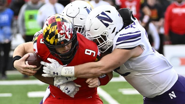 Oct 22, 2022; College Park, Maryland, USA; Northwestern Wildcats linebacker Bryce Gallagher (32) and Northwestern Wildcats defensive back Rod Heard II (24) sack Maryland Terrapins quarterback Billy Edwards Jr. (9) during the first half at SECU Stadium. Mandatory Credit: Brad Mills-USA TODAY Sports