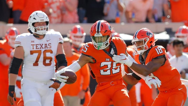 Oklahoma State Cowboys safety Jason Taylor II (25) celebrates after an interception beside safety Sean Michael Flanagan (18) as Texas Longhorns offensive lineman Hayden Conner (76) walks away during a college football game between the Oklahoma State Cowboys (OSU) and the University of Texas Longhorns at Boone Pickens Stadium in Stillwater, Okla., Saturday, Oct. 22, 2022.

Osu Vs Texas Football