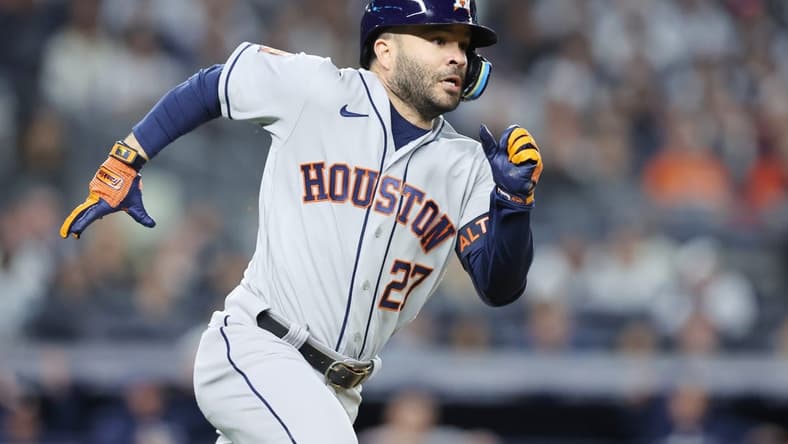 Oct 22, 2022; Bronx, New York, USA; Houston Astros second baseman Jose Altuve (27) hits a double in the fifth inn against the New York Yankees during game three of the ALCS for the 2022 MLB Playoffs at Yankee Stadium. Mandatory Credit: Brad Penner-USA TODAY Sports
