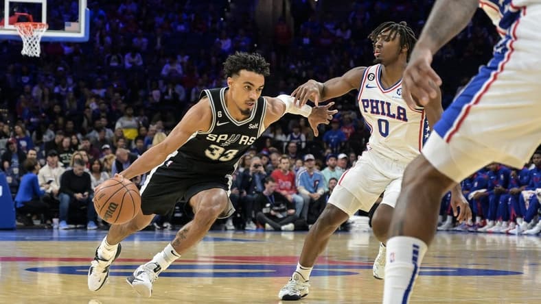 Oct 22, 2022; Philadelphia, Pennsylvania, USA; San Antonio Spurs guard Tre Jones (33) moves to the net as Philadelphia 76ers guard Tyrese Maxey (0) defends during the first quarter of the game at Wells Fargo Center. Mandatory Credit: John Geliebter-USA TODAY Sports
