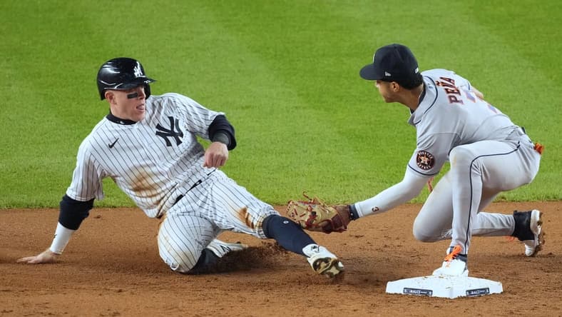 Oct 22, 2022; Bronx, New York, USA; New York Yankees center fielder Harrison Bader (22) is out at second by Houston Astros shortstop Jeremy Pena (3) after caught stealing in the fifth inning during game three of the ALCS for the 2022 MLB Playoffs at Yankee Stadium. Mandatory Credit: Robert Deutsch-USA TODAY Sports