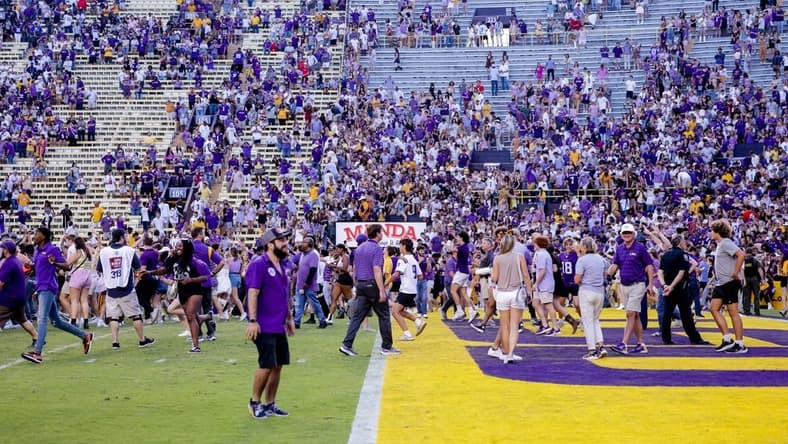 Oct 22, 2022; Baton Rouge, Louisiana, USA; LSU Tigers fans storm the field after LSU defeated the Mississippi Rebels at Tiger Stadium. Mandatory Credit: Stephen Lew-USA TODAY Sports