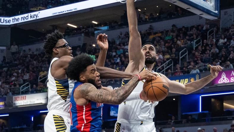 Oct 22, 2022; Indianapolis, Indiana, USA; Detroit Pistons forward Saddiq Bey (41) and Indiana Pacers forward Jalen Smith (25) fight for a rebound in the second quarter at Gainbridge Fieldhouse. Mandatory Credit: Trevor Ruszkowski-USA TODAY Sports