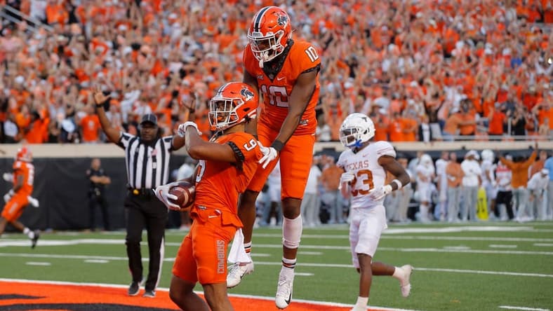 Oklahoma State receiver Bryson Green (9) celebrates beside receiver Rashod Owens (10) after scoring a touchdown in the fourth quarter of a 41-34 win against Texas on Saturday at Boone Pickens Stadium in Stillwater.

cover main