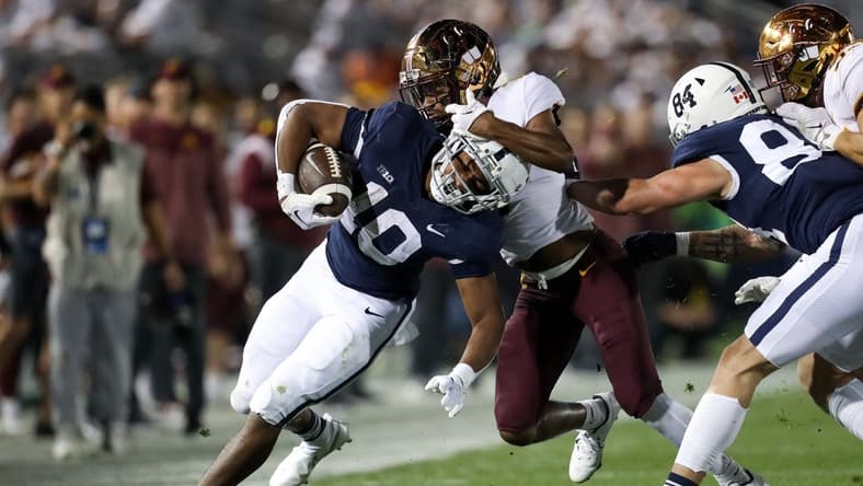 Oct 22, 2022; University Park, Pennsylvania, USA; Penn State Nittany Lions running back Nicholas Singleton (10) runs with the ball as Minnesota Golden Gophers defensive back Beanie Bishop (7) attempts a tackle during the second quarter at Beaver Stadium. Mandatory Credit: Matthew OHaren-USA TODAY Sports