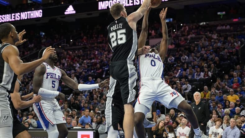 Oct 22, 2022; Philadelphia, Pennsylvania, USA; San Antonio Spurs center Jakob Poeltl (25) blocks a shot by Philadelphia 76ers guard Tyrese Maxey (0) during the fourth quarter at Wells Fargo Center. San Antonio won 114-105. Mandatory Credit: John Geliebter-USA TODAY Sports