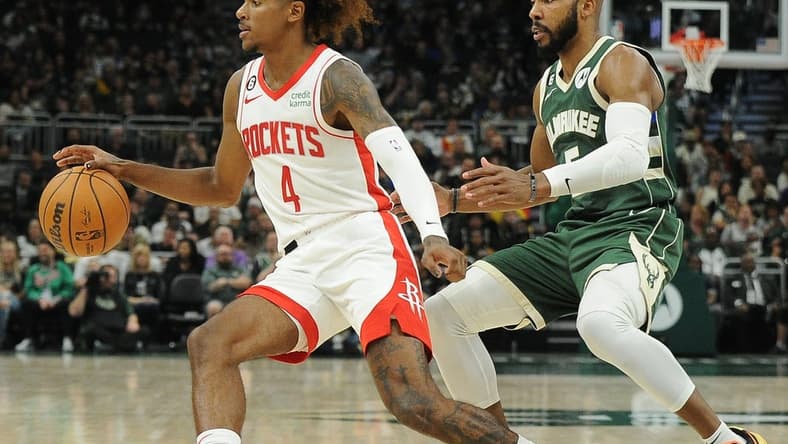 Oct 22, 2022; Milwaukee, Wisconsin, USA; Houston Rockets guard Jalen Green (4) brings the ball up the court against Milwaukee Bucks guard Jevon Carter (5) in the third quarter at Fiserv Forum. Mandatory Credit: Michael McLoone-USA TODAY Sports