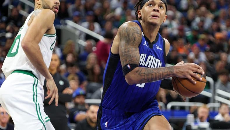 Oct 22, 2022; Orlando, Florida, USA; Orlando Magic forward Paolo Banchero (5) drives to the hoop past Boston Celtics forward Jayson Tatum (0) in the fourth quarter at Amway Center. Mandatory Credit: Nathan Ray Seebeck-USA TODAY Sports