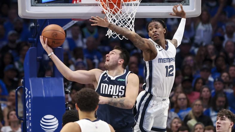Oct 22, 2022; Dallas, Texas, USA; Dallas Mavericks guard Luka Doncic (77) shoots as Memphis Grizzlies guard Ja Morant (12) defends during the second half at American Airlines Center. Mandatory Credit: Kevin Jairaj-USA TODAY Sports