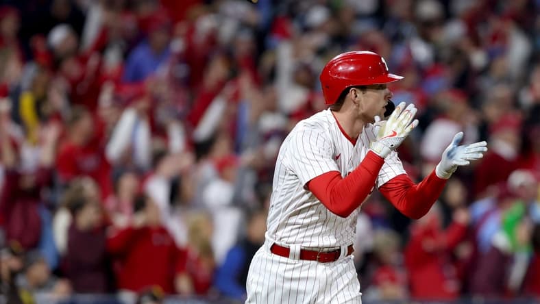 Oct 22, 2022; Philadelphia, Pennsylvania, USA; Philadelphia Phillies first baseman Rhys Hoskins (17) flips his bat after hitting a two-run home run in the fifth inning during game four of the NLCS against the San Diego Padres for the 2022 MLB Playoffs at Citizens Bank Park. Mandatory Credit: Bill Streicher-USA TODAY Sports