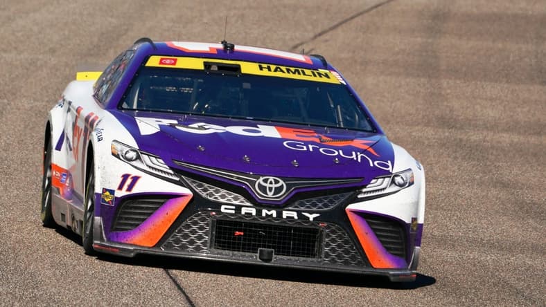 Oct 23, 2022; Homestead, Florida, USA; NASCAR Cup Series driver Denny Hamlin (11) races into turn one during the Dixie Vodka 400 at Homestead-Miami Speedway. Mandatory Credit: John David Mercer-USA TODAY Sports