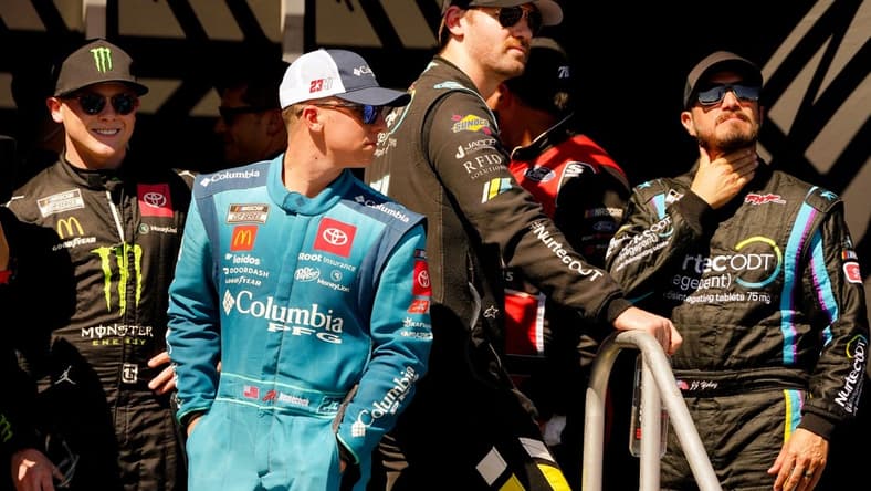 Oct 23, 2022; Homestead, Florida, USA; NASCAR Cup Series driver Ty Gibbs (23) driver John Hunter Nemecheck (45) , driver Cody Ware (51) and driver JJ Yeley (15) wait for driver introductions before the Dixie Vodka 400 at Homestead-Miami Speedway. Mandatory Credit: John David Mercer-USA TODAY Sports