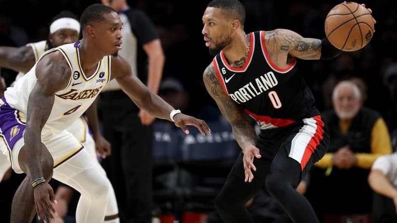 Oct 23, 2022; Los Angeles, California, USA; Portland Trail Blazers guard Damian Lillard (0) dribbles the ball against Los Angeles Lakers guard Lonnie Walker IV (4) during the second half at Crypto.com Arena. Mandatory Credit: Kiyoshi Mio-USA TODAY Sports