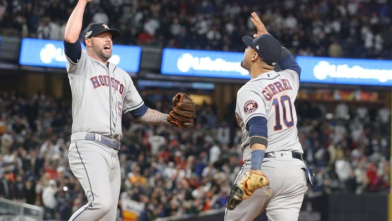 Oct 23, 2022; Bronx, New York, USA; Houston Astros relief pitcher Ryan Pressly (55) celebrates getting the final out of the game with first baseman Yuli Gurriel (10) in the ninth inning against the New York Yankees during game four of the ALCS for the 2022 MLB Playoffs at Yankee Stadium. Mandatory Credit: Brad Penner-USA TODAY Sports