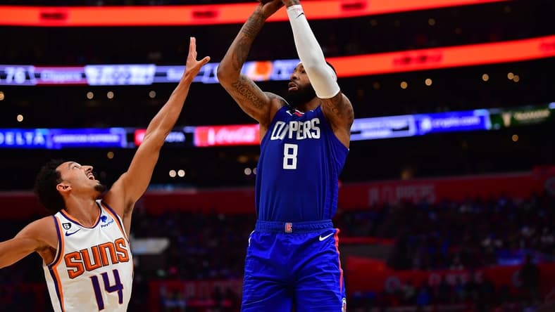Oct 23, 2022; Los Angeles, California, USA; Los Angeles Clippers forward Marcus Morris Sr. (8) shoots against Phoenix Suns guard Landry Shamet (14) during the second half at Crypto.com Arena. Mandatory Credit: Gary A. Vasquez-USA TODAY Sports