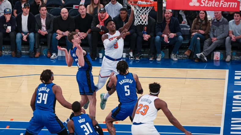 Oct 24, 2022; New York, New York, USA; New York Knicks guard RJ Barrett (9) drives to the basket as Orlando Magic forward Paolo Banchero (5) and forward Franz Wagner (22) defend at Madison Square Garden. Mandatory Credit: Vincent Carchietta-USA TODAY Sports