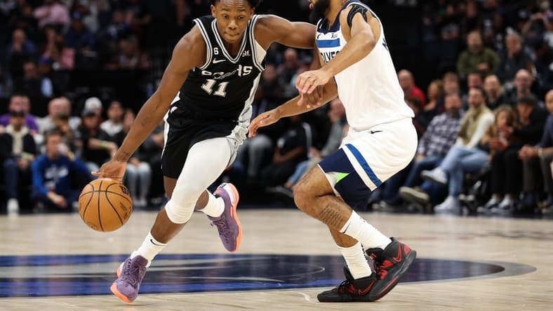 Oct 24, 2022; Minneapolis, Minnesota, USA; San Antonio Spurs guard Joshua Primo (11) dribbles while Minnesota Timberwolves guard Jordan McLaughlin (6) defends during the first quarter at Target Center. Mandatory Credit: Matt Krohn-USA TODAY Sports