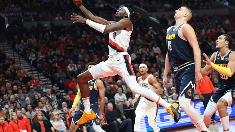 Oct 24, 2022; Portland, Oregon, USA;  Portland Trail Blazers forward Jerami Grant (9) shoots over Denver Nuggets center Nikola Jokic (15) in the first half at Moda Center. Mandatory Credit: Jaime Valdez-USA TODAY Sports