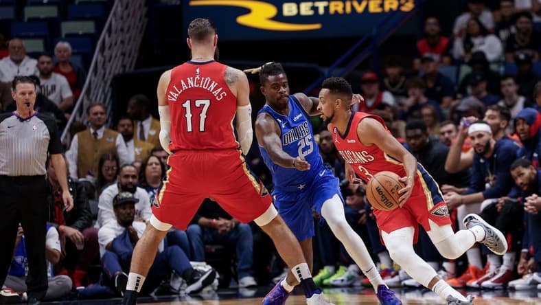 Oct 25, 2022; New Orleans, Louisiana, USA; New Orleans Pelicans guard CJ McCollum (3) dribbles against Dallas Mavericks forward Reggie Bullock (25) during the first half at Smoothie King Center. Mandatory Credit: Stephen Lew-USA TODAY Sports