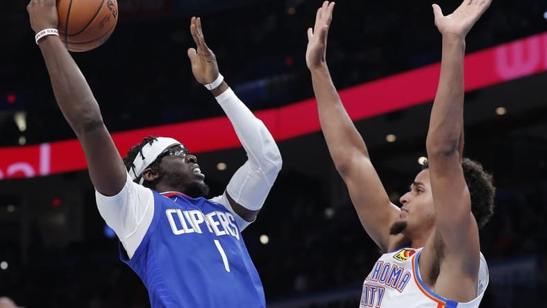 Oct 25, 2022; Oklahoma City, Oklahoma, USA; LA Clippers guard Reggie Jackson (1) shoots as Oklahoma City Thunder forward Jeremiah Robinson-Earl (50) defends the shot during the second half at Paycom Center. Oklahoma City won 108-94. Mandatory Credit: Alonzo Adams-USA TODAY Sports