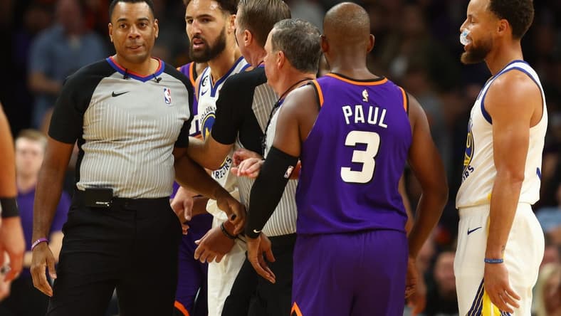 Oct 25, 2022; Phoenix, Arizona, USA; Golden State Warriors guard Klay Thompson (second from left) is held back by referees after being ejected from the game against the Phoenix Suns in the second half at Footprint Center. Mandatory Credit: Mark J. Rebilas-USA TODAY Sports