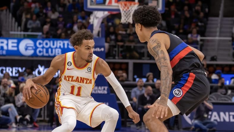 Oct 26, 2022; Detroit, Michigan, USA; Atlanta Hawks guard Trae Young (11) moves the ball up court against Detroit Pistons guard Killian Hayes (7) during the first half at Little Caesars Arena. Mandatory Credit: David Reginek-USA TODAY Sports